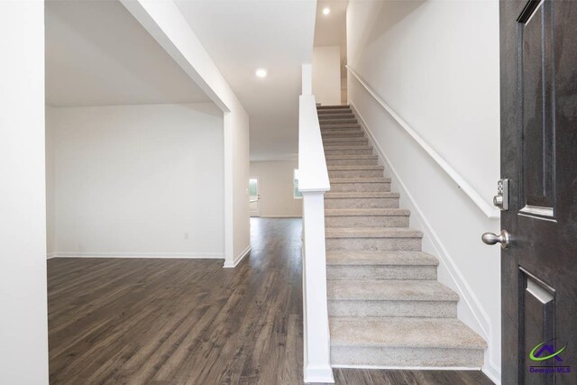 stairway featuring hardwood / wood-style floors