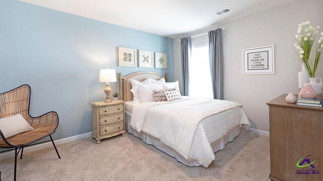 bedroom featuring light colored carpet