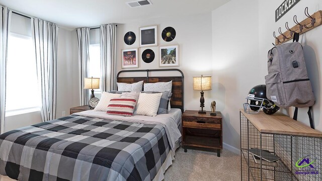 bedroom featuring light carpet