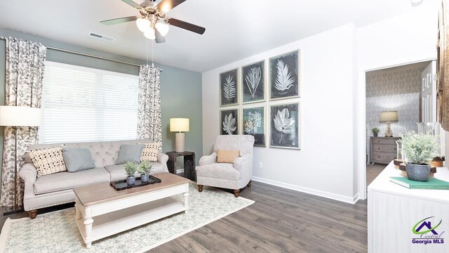 living room featuring dark hardwood / wood-style flooring and ceiling fan