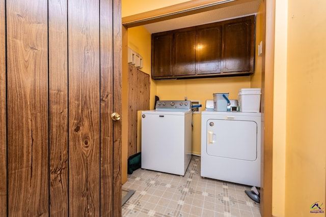 laundry area featuring washer and dryer and cabinets