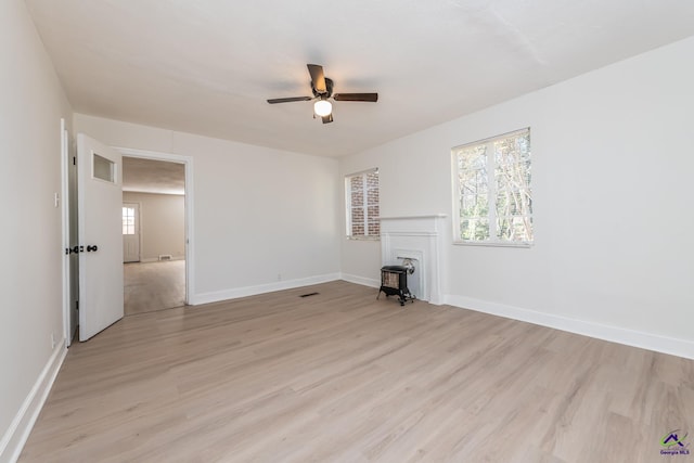 unfurnished living room with a fireplace, light hardwood / wood-style floors, and ceiling fan