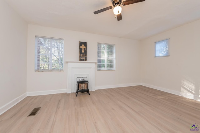 unfurnished living room with ceiling fan and light hardwood / wood-style floors