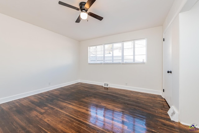 spare room with dark hardwood / wood-style floors and ceiling fan