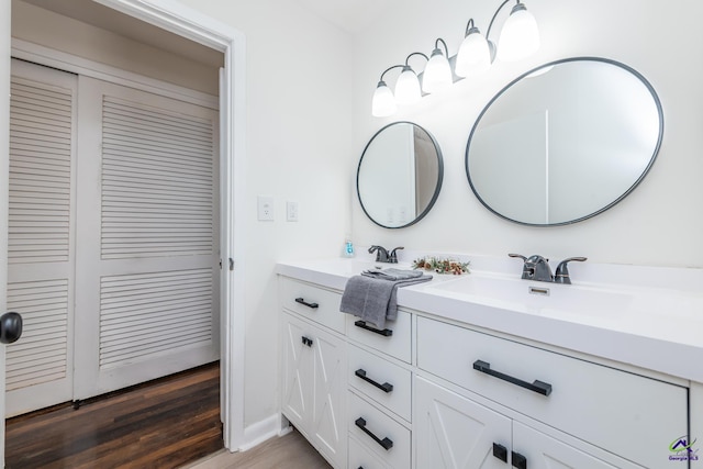 bathroom with vanity and hardwood / wood-style flooring