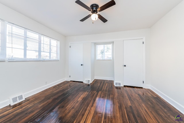 spare room with dark hardwood / wood-style floors and a wealth of natural light