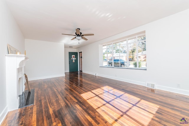 unfurnished living room featuring dark hardwood / wood-style floors and ceiling fan