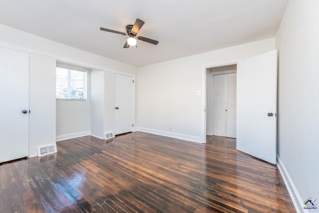 unfurnished bedroom featuring ceiling fan and dark hardwood / wood-style floors