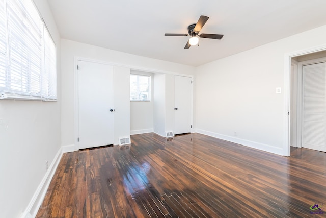 empty room with ceiling fan and dark wood-type flooring