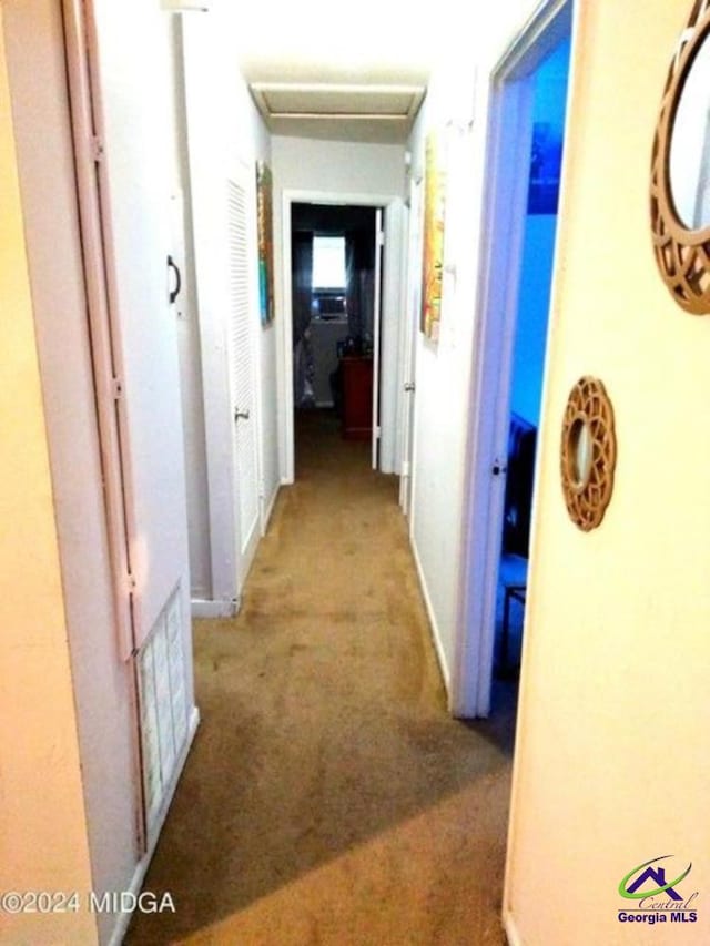 hall with light colored carpet