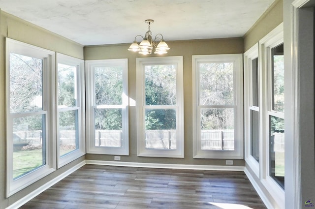 unfurnished sunroom with plenty of natural light and a chandelier