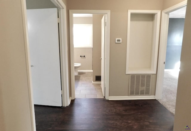 hallway with dark wood-type flooring