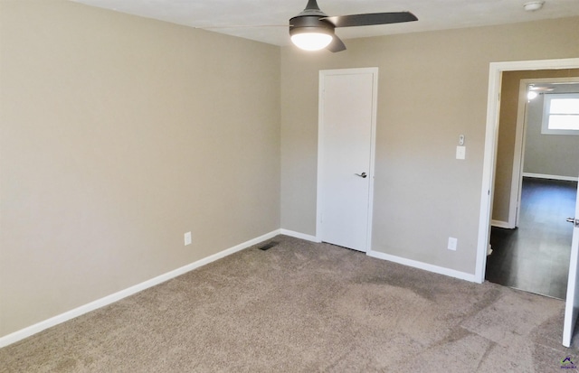 unfurnished bedroom featuring light carpet and ceiling fan