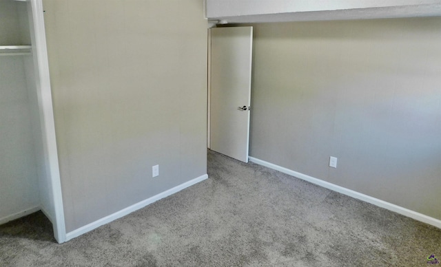 unfurnished bedroom with carpet flooring and a closet