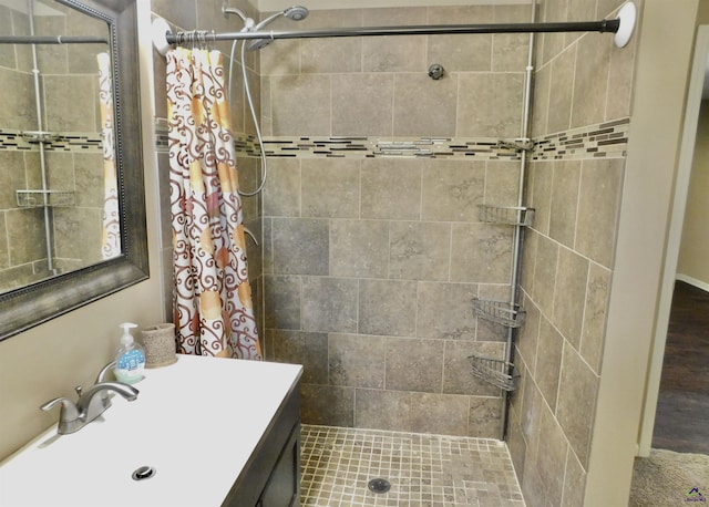 bathroom with curtained shower and vanity