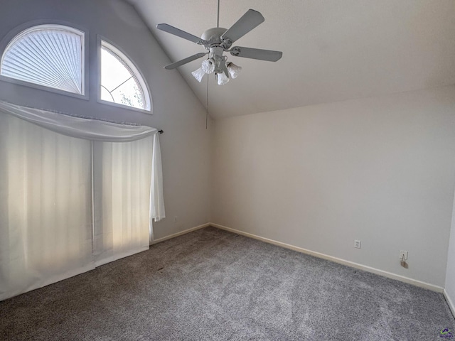 carpeted spare room featuring ceiling fan and vaulted ceiling