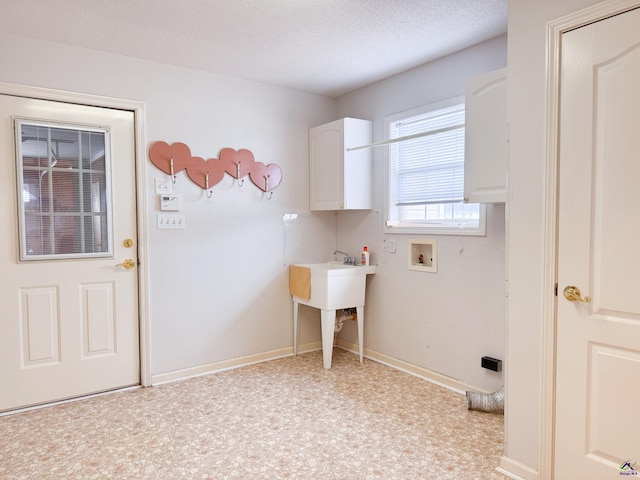 laundry area featuring washer hookup and a textured ceiling