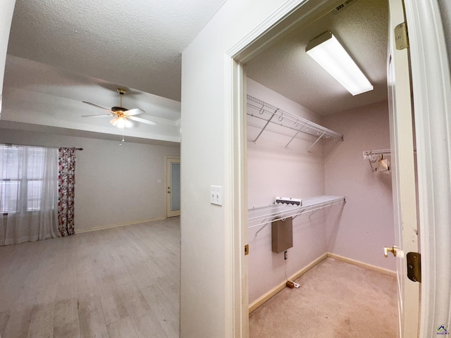 walk in closet featuring ceiling fan