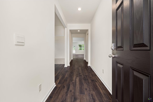 corridor featuring dark wood-type flooring