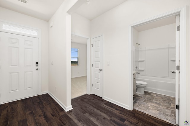 entryway with dark hardwood / wood-style flooring