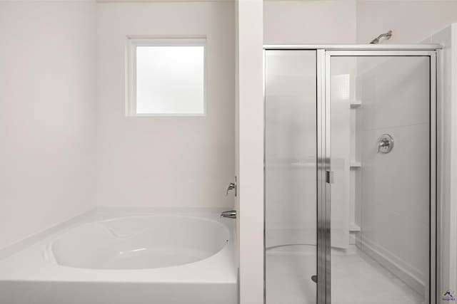 bathroom with shower with separate bathtub