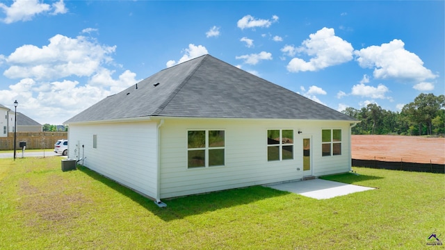 back of property featuring a yard and a patio