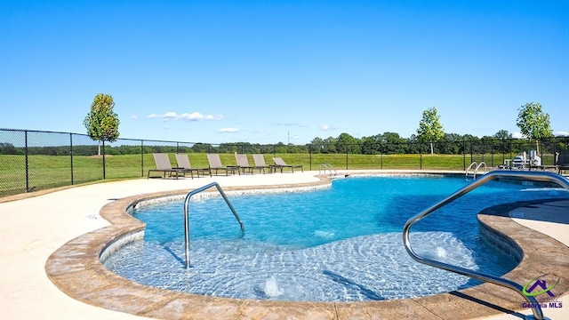 view of swimming pool with a patio area