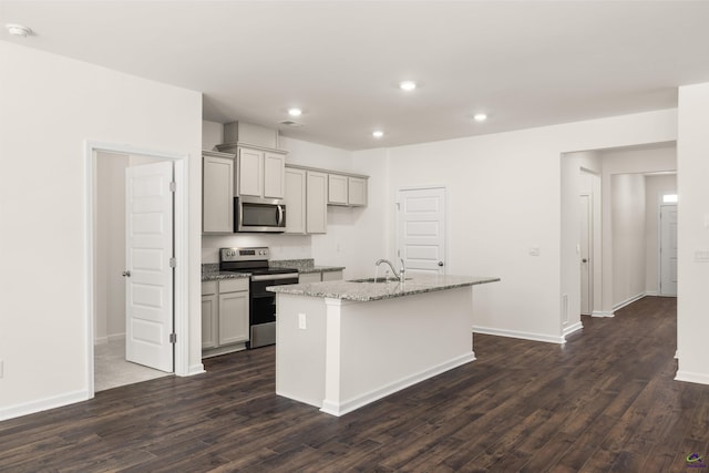 kitchen featuring gray cabinets, sink, an island with sink, and stainless steel appliances