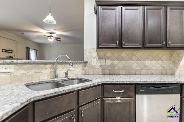 kitchen with sink, hanging light fixtures, stainless steel dishwasher, light stone counters, and dark brown cabinetry