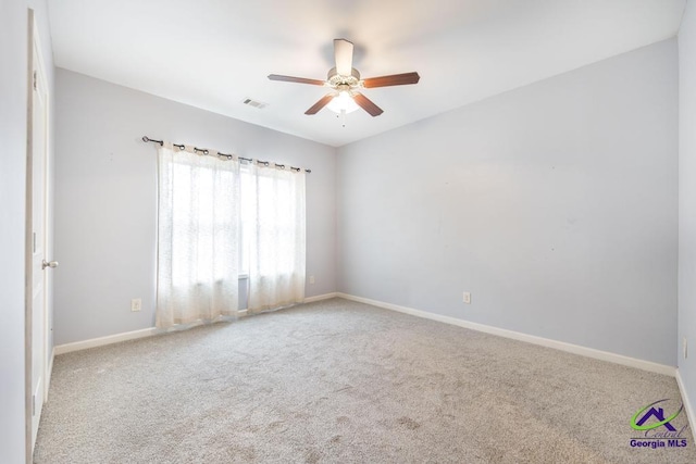 carpeted spare room featuring ceiling fan