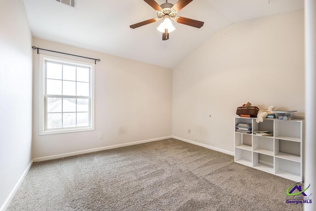 carpeted empty room featuring ceiling fan and vaulted ceiling