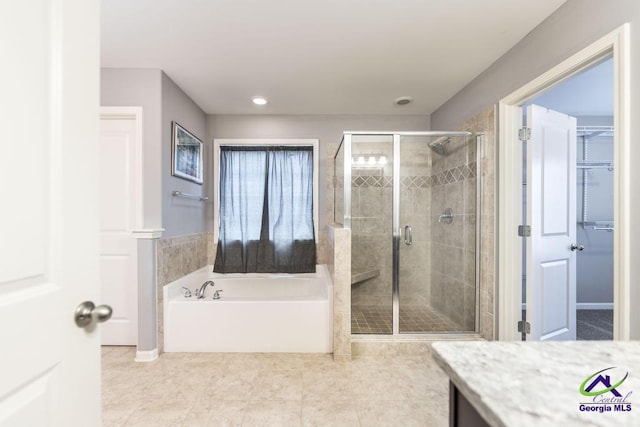 bathroom featuring plus walk in shower and vanity