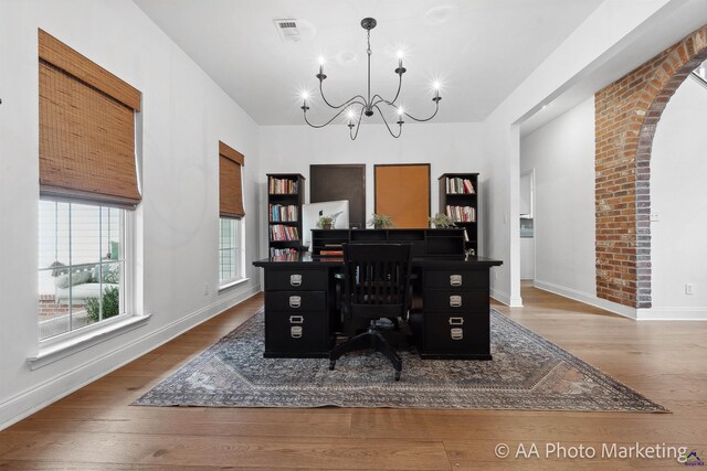 dining room with dark wood-type flooring and a notable chandelier