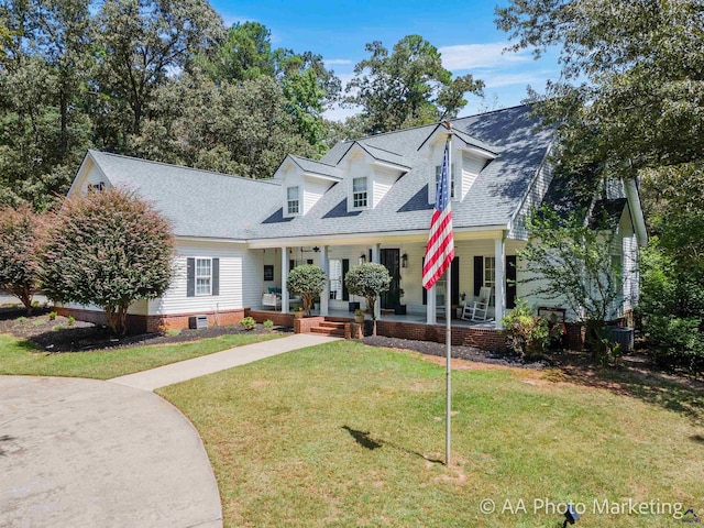 cape cod house featuring a front lawn and a porch