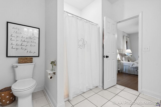 bathroom with tile patterned floors and toilet