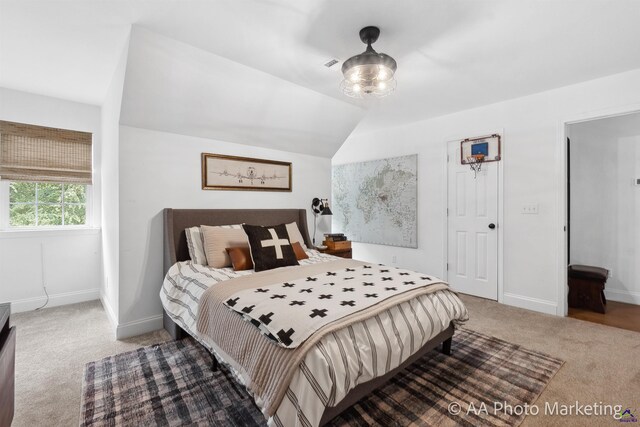 bedroom featuring carpet floors and vaulted ceiling