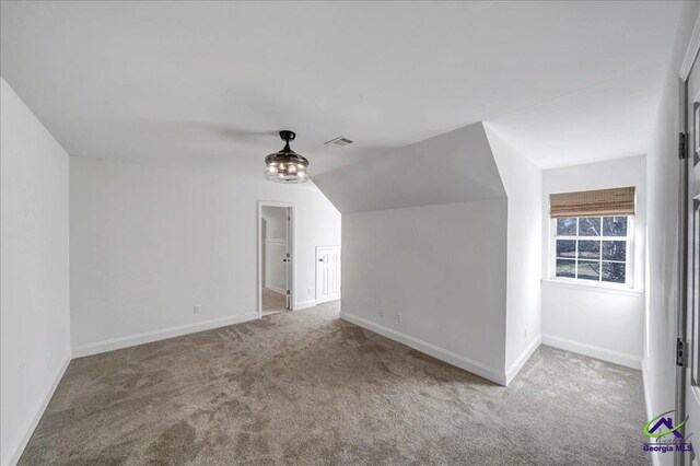 bonus room featuring carpet floors and lofted ceiling