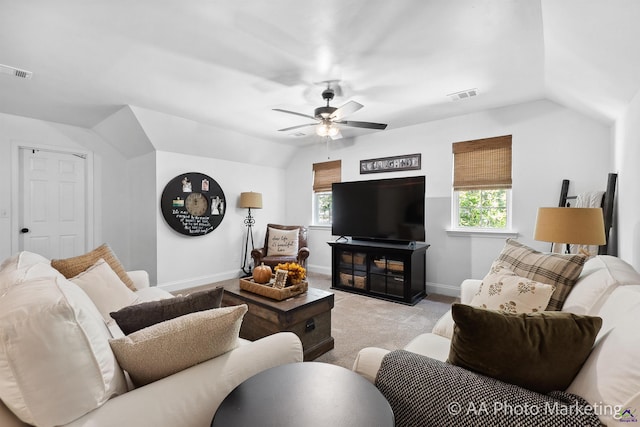 carpeted living room with ceiling fan and lofted ceiling