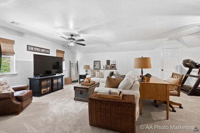 carpeted living room featuring ceiling fan and vaulted ceiling