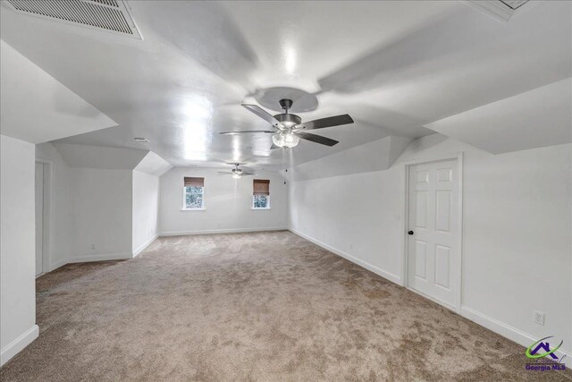 additional living space with light carpet, ceiling fan, and lofted ceiling