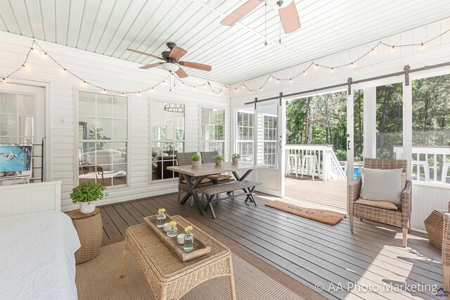 sunroom with ceiling fan and wood ceiling