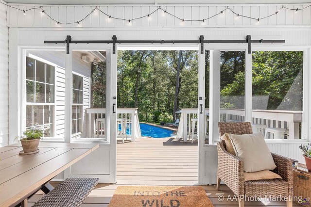 exterior space featuring wood walls, wood-type flooring, and a wealth of natural light