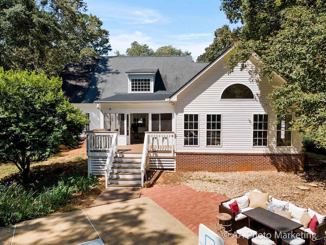 view of front of property with a patio, an outdoor living space, and a deck