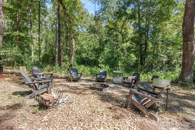 view of yard featuring an outdoor fire pit