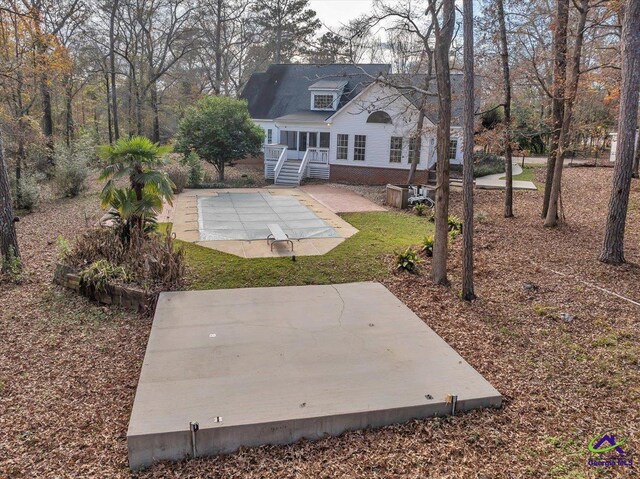 rear view of property featuring a patio area and a yard