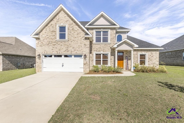 view of front of home with a front yard and a garage