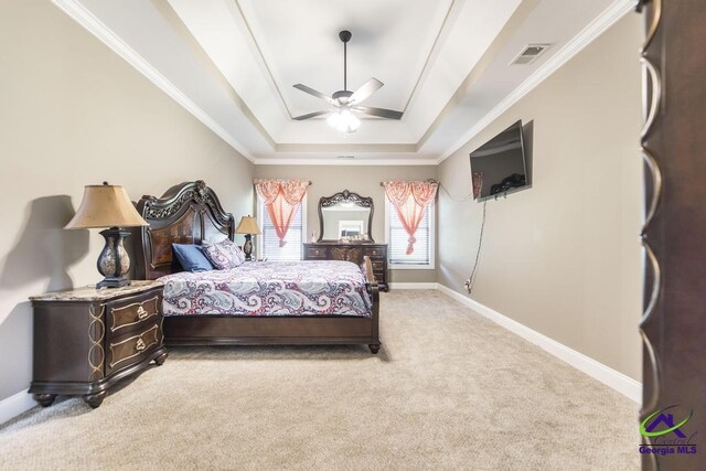 carpeted bedroom featuring a raised ceiling, ceiling fan, and crown molding