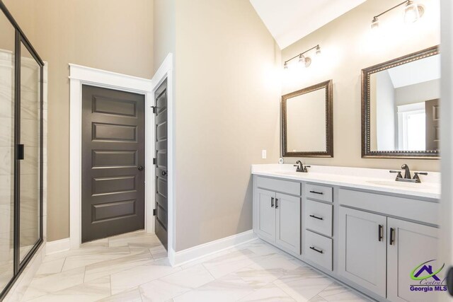 bathroom featuring a shower with door, vanity, and vaulted ceiling