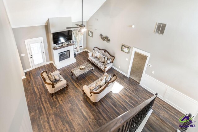 living room with ceiling fan, dark wood-type flooring, and high vaulted ceiling