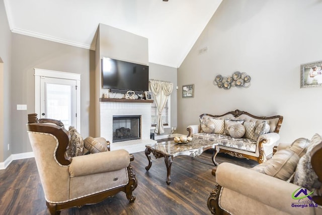 living room featuring dark hardwood / wood-style floors, crown molding, a fireplace, and high vaulted ceiling